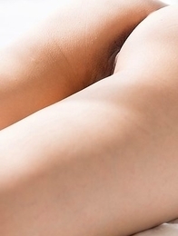 Chie Kobayashi laying on a beautiful bed while brazenly showing her legs/feet